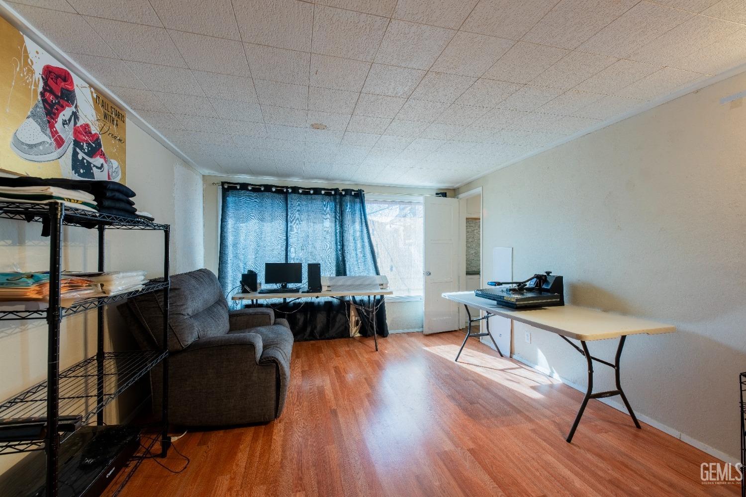 Undisclosed Address Bakersfield, CA 93305 - Photo 15 of 27 a living room with furniture and wooden floor