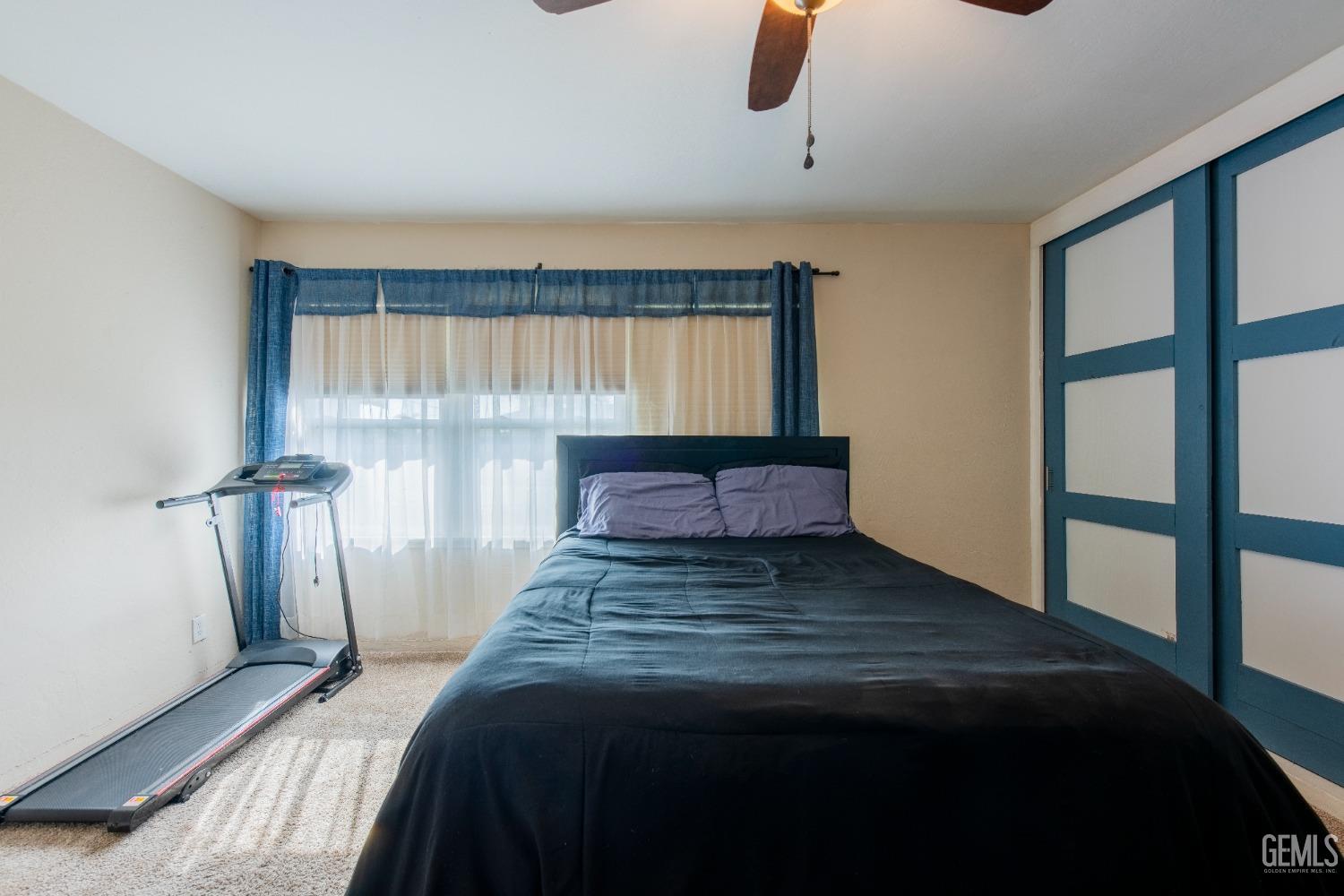 Undisclosed Address Bakersfield, CA 93305 - Photo 19 of 27 a bedroom with a bed and a window