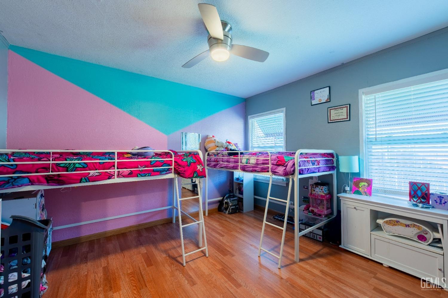 Undisclosed Address Bakersfield, CA 93305 - Photo 22 of 27 a bedroom with furniture and a wooden floor