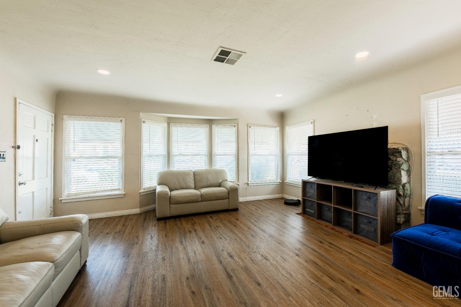 Undisclosed Address Bakersfield, CA 93305 - Photo 7 of 27 a living room with furniture and a flat screen tv