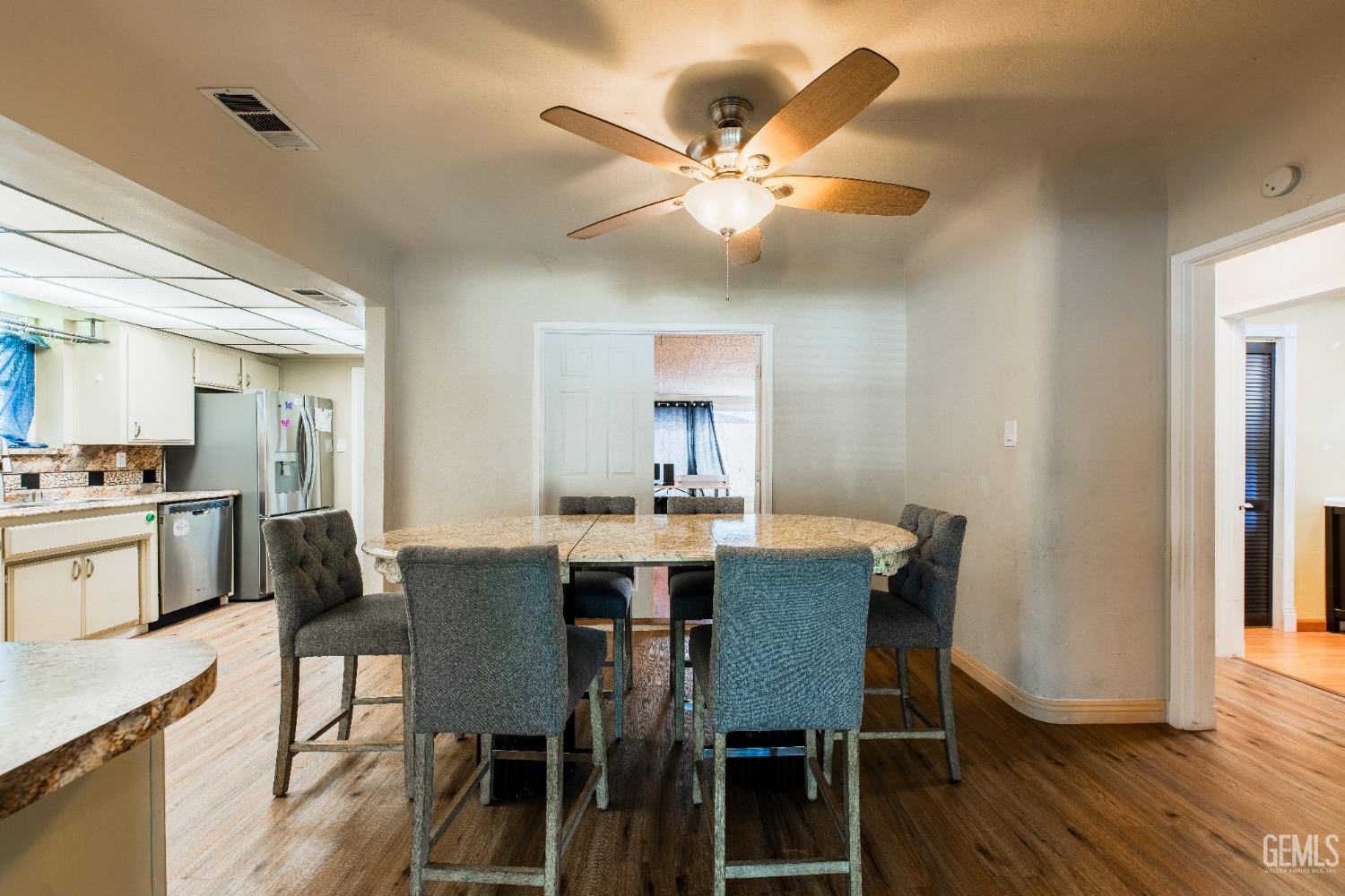 Undisclosed Address Bakersfield, CA 93305 - Photo 9 of 27 a view of a dining room with furniture and wooden floor