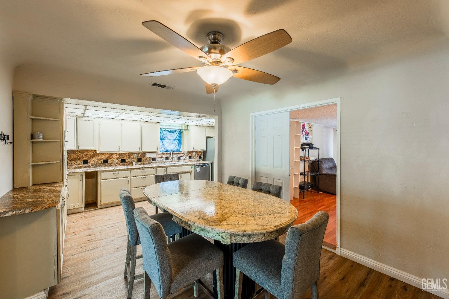 Undisclosed Address Bakersfield, CA 93305 - Photo 10 of 27 a view of a dining room with furniture and wooden floor