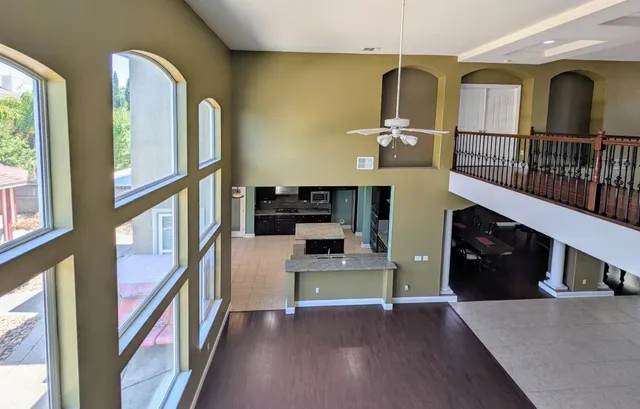 a kitchen with granite countertop stainless steel appliances wooden cabinets and a stove