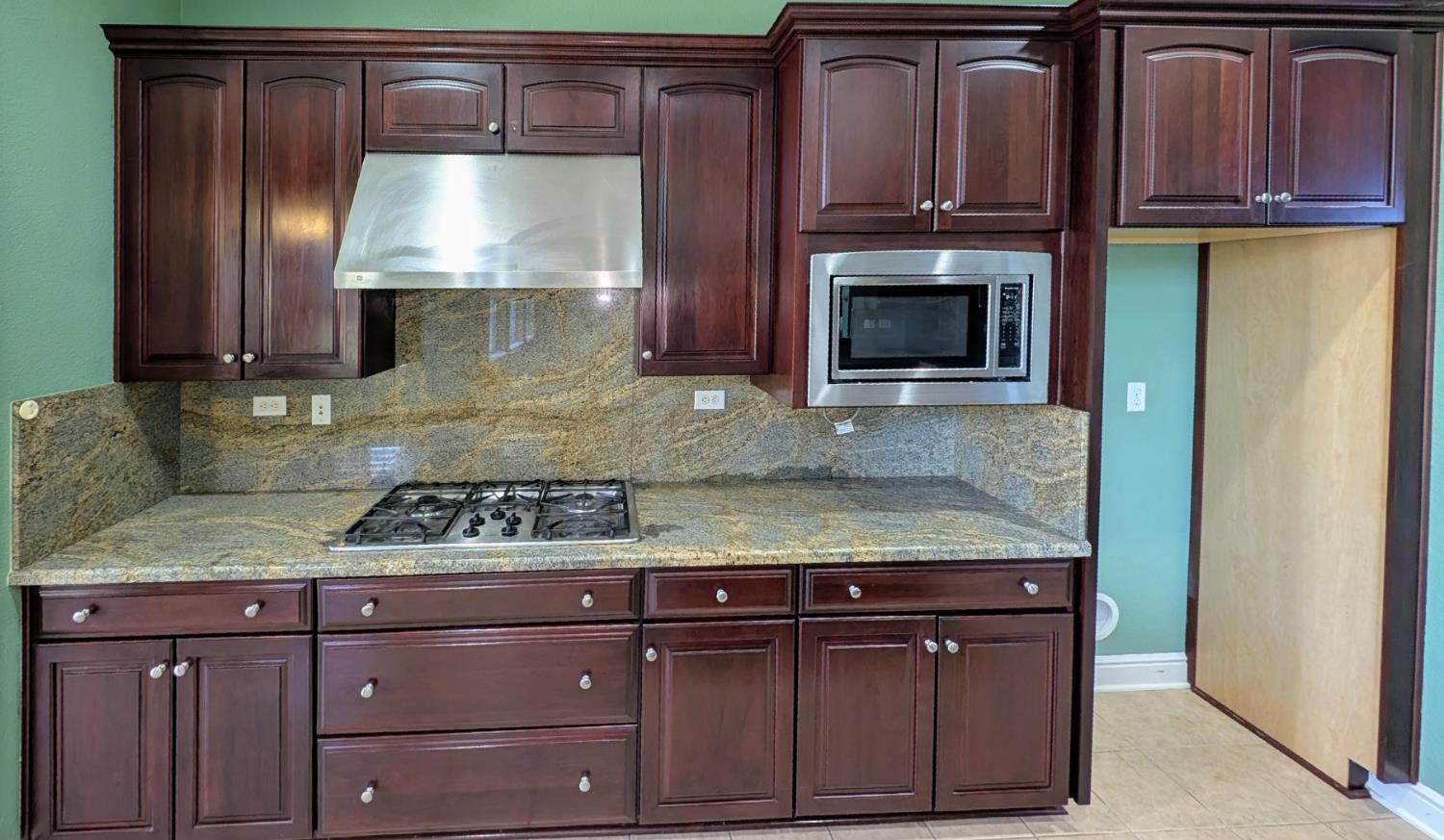 4389 Kilroy Court Rancho Cordova, CA 95742 - Photo 13 of 47 a kitchen with granite countertop stainless steel appliances wooden cabinets and a stove