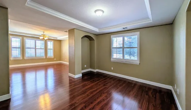 a view of interior space with wooden floor and large windows