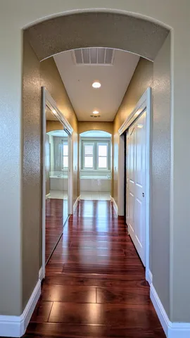 a en suite bathroom with a granite countertop sink and a mirror