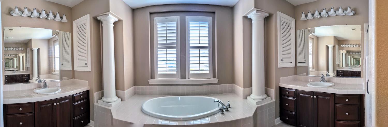 4389 Kilroy Court Rancho Cordova, CA 95742 - Photo 29 of 47 a en suite bathroom with a granite countertop sink and a mirror