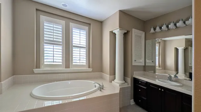 a bathroom with a bathtub and next to a window