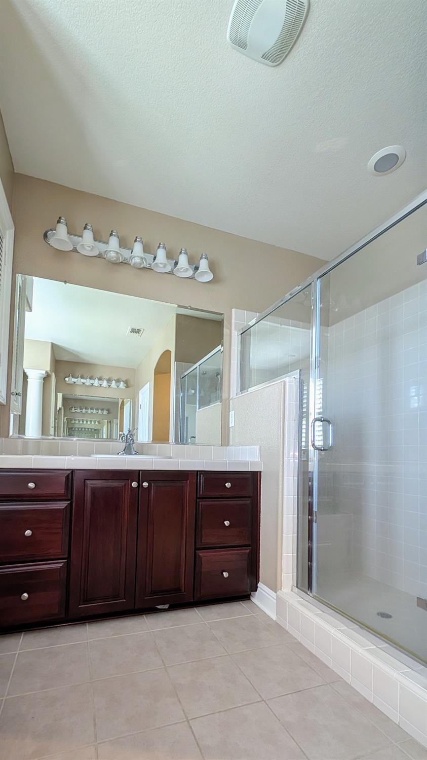 4389 Kilroy Court Rancho Cordova, CA 95742 - Photo 33 of 47 a bathroom with a granite countertop sink and a mirror
