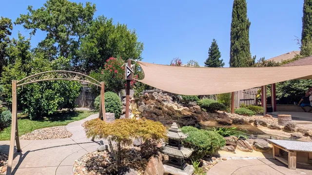 a view of a backyard with a patio