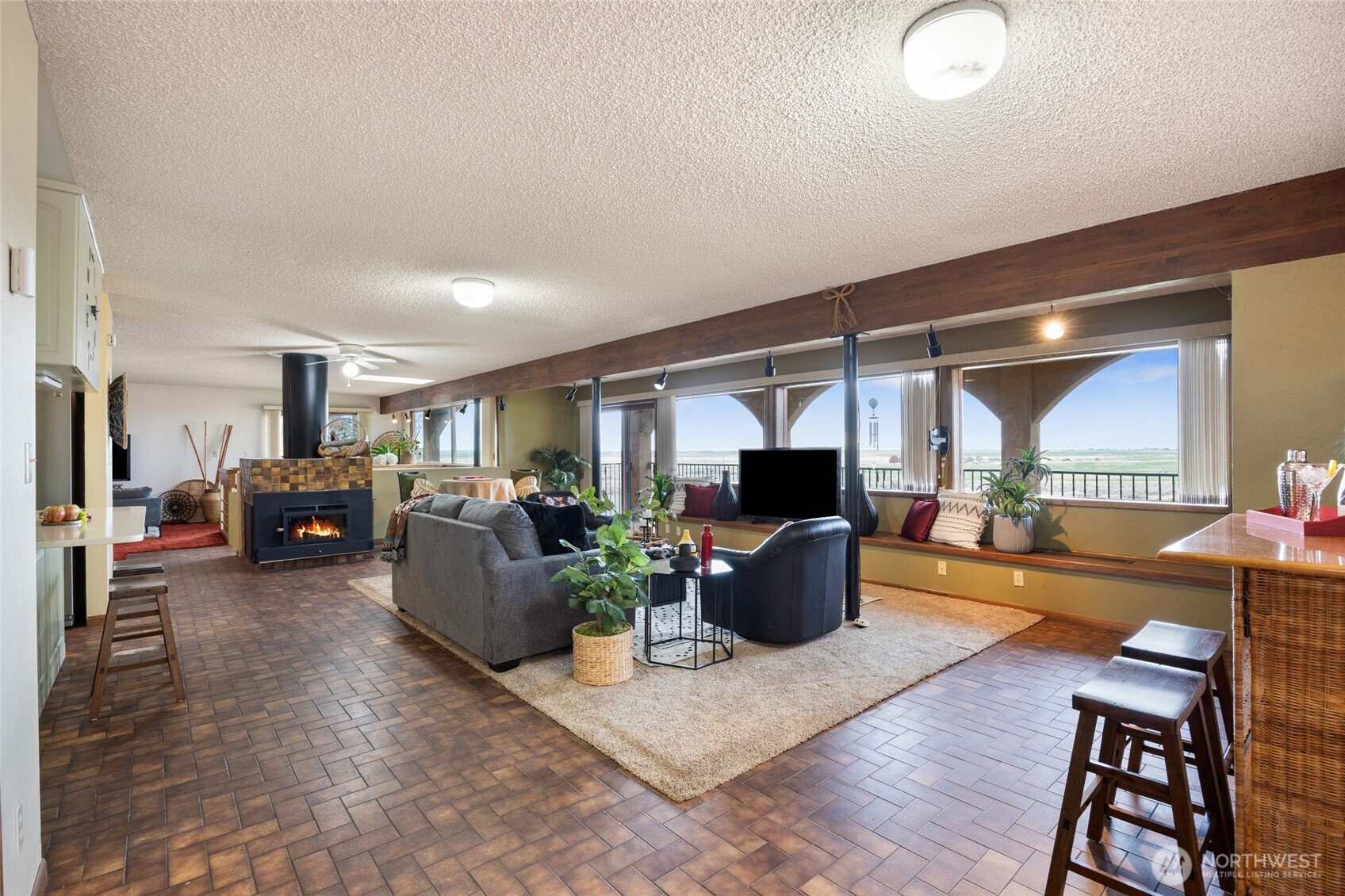 18850 Stratford Road Northeast Moses Lake, WA 98837 - Photo 11 of 40 a living room with furniture a flat screen tv and a large window