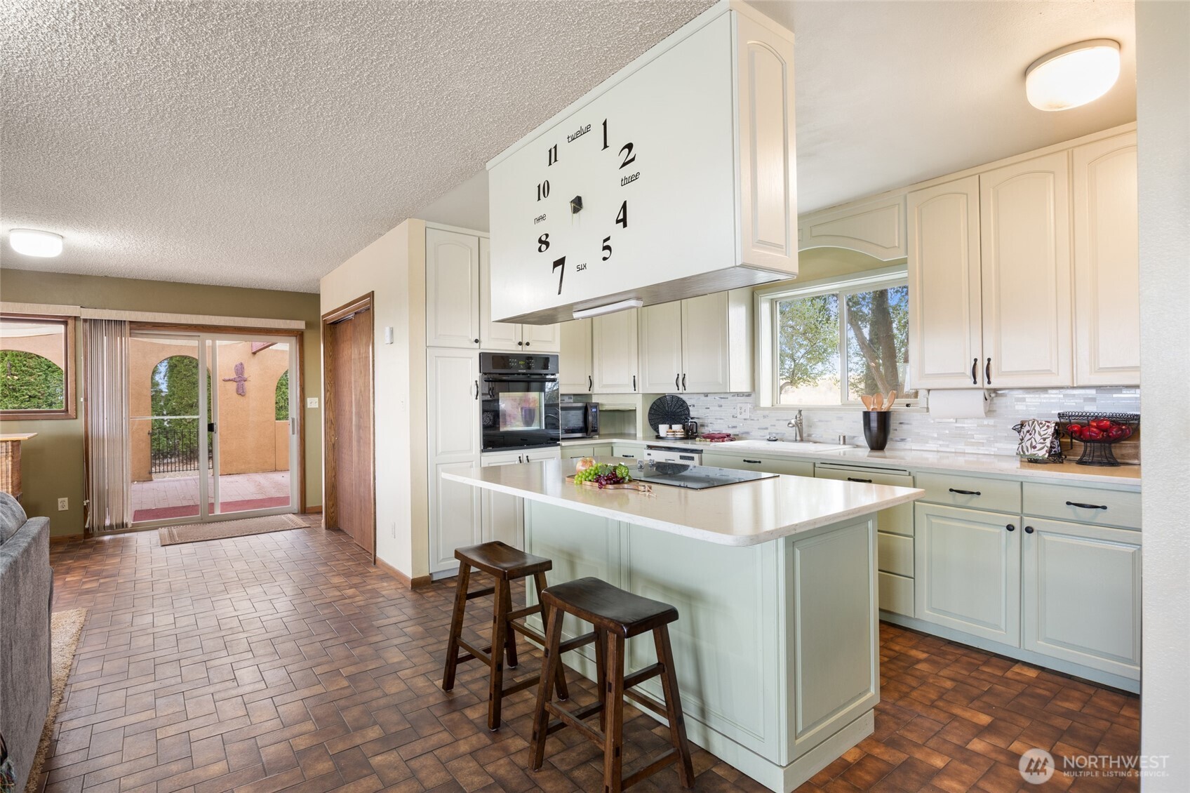 18850 Stratford Road Northeast Moses Lake, WA 98837 - Photo 20 of 40 a large kitchen with kitchen island a sink a stove a refrigerator and cabinets