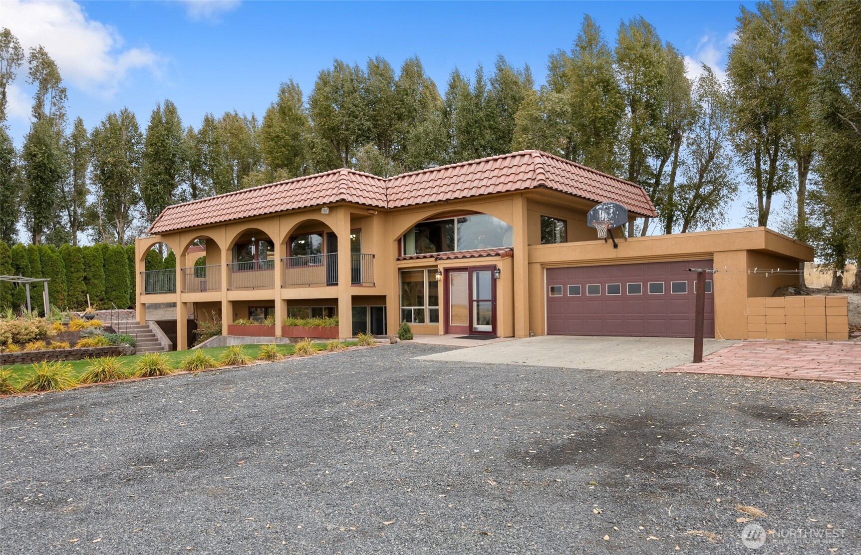 18850 Stratford Road Northeast Moses Lake, WA 98837 - Photo 3 of 40 a view of a house with a yard and large trees