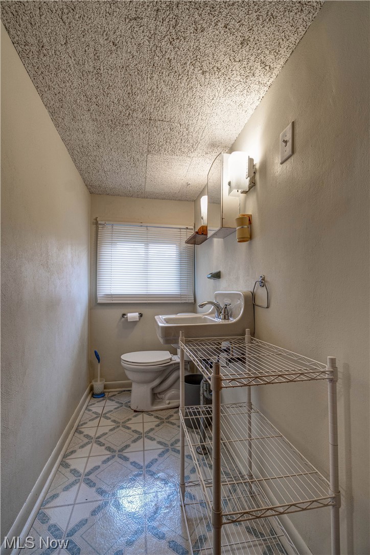 4932 Arbor Road Southwest Canton, OH 44710 - Photo 28 of 31 2nd floor Bathroom featuring washbasin, light tile flooring, and mirror