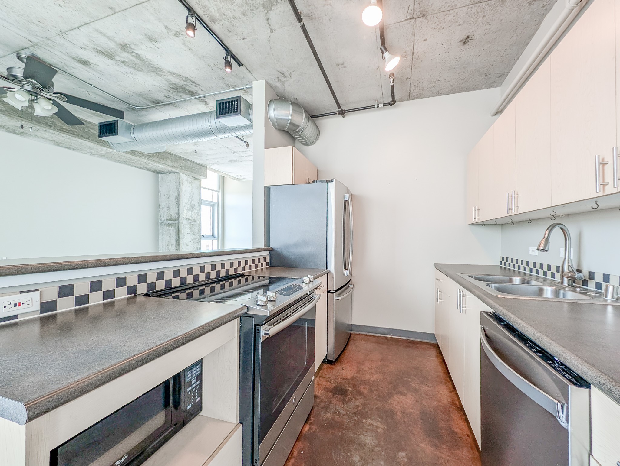 2000 Bagby Street, Unit 7417 Houston, TX 77002 - Photo 4 of 11 a kitchen with stainless steel appliances granite countertop a sink stove and cabinets