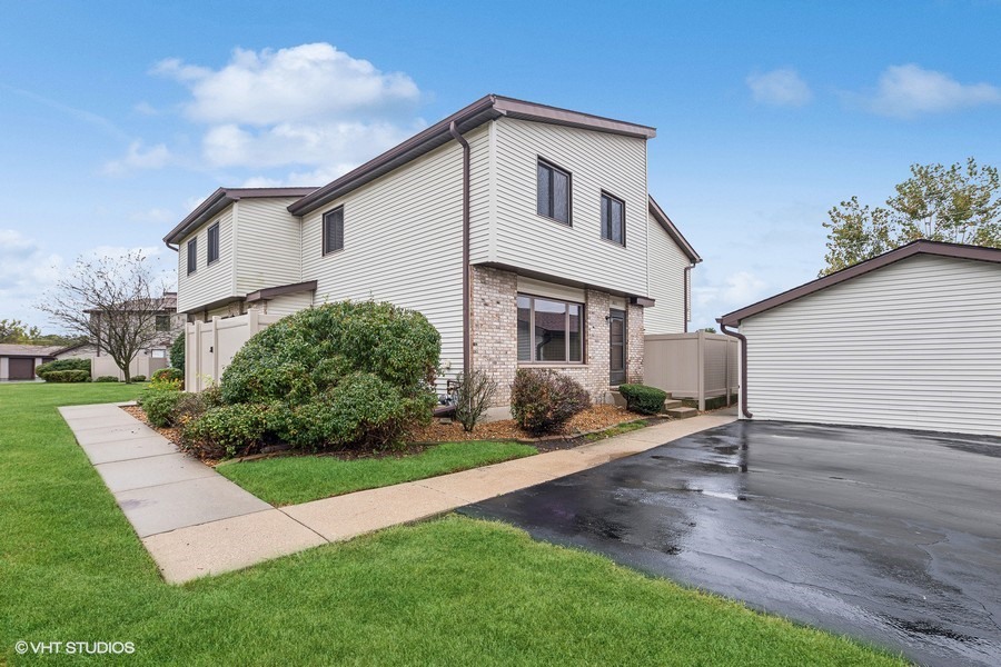 1073 Southgate Road New Lenox, IL 60451 - Photo 2 of 18 a front view of a house with a yard and garage