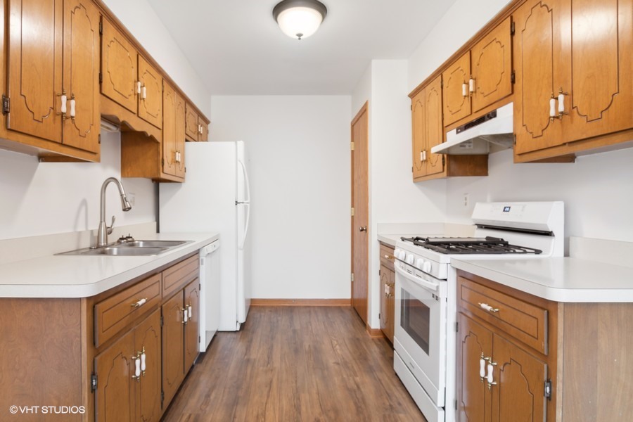 1073 Southgate Road New Lenox, IL 60451 - Photo 6 of 18 a kitchen with a sink a stove and cabinets