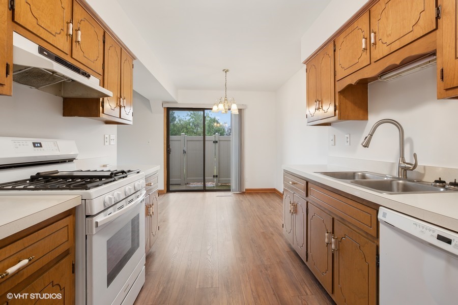 1073 Southgate Road New Lenox, IL 60451 - Photo 7 of 18 a kitchen with stainless steel appliances granite countertop a sink stove and cabinets