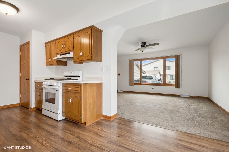 1073 Southgate Road New Lenox, IL 60451 - Photo 8 of 18 a view of kitchen with stainless steel appliances wooden floor and a window