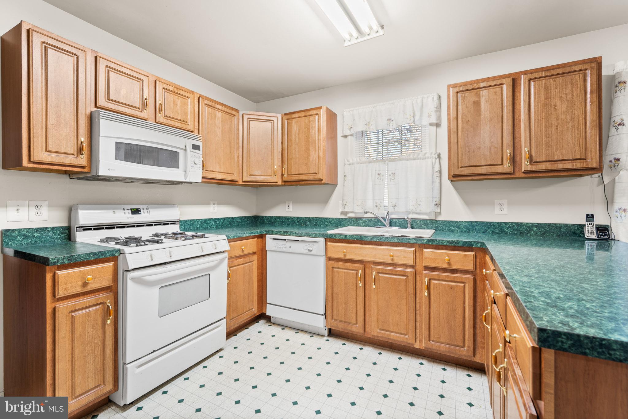 202 North New York Road Galloway Township, NJ 08205 - Photo 13 of 34 a kitchen with stainless steel appliances granite countertop a stove a sink and a microwave