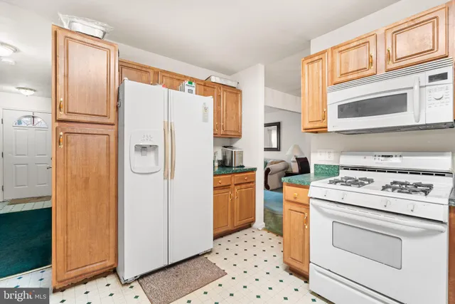 a kitchen with stainless steel appliances a refrigerator and a stove top oven