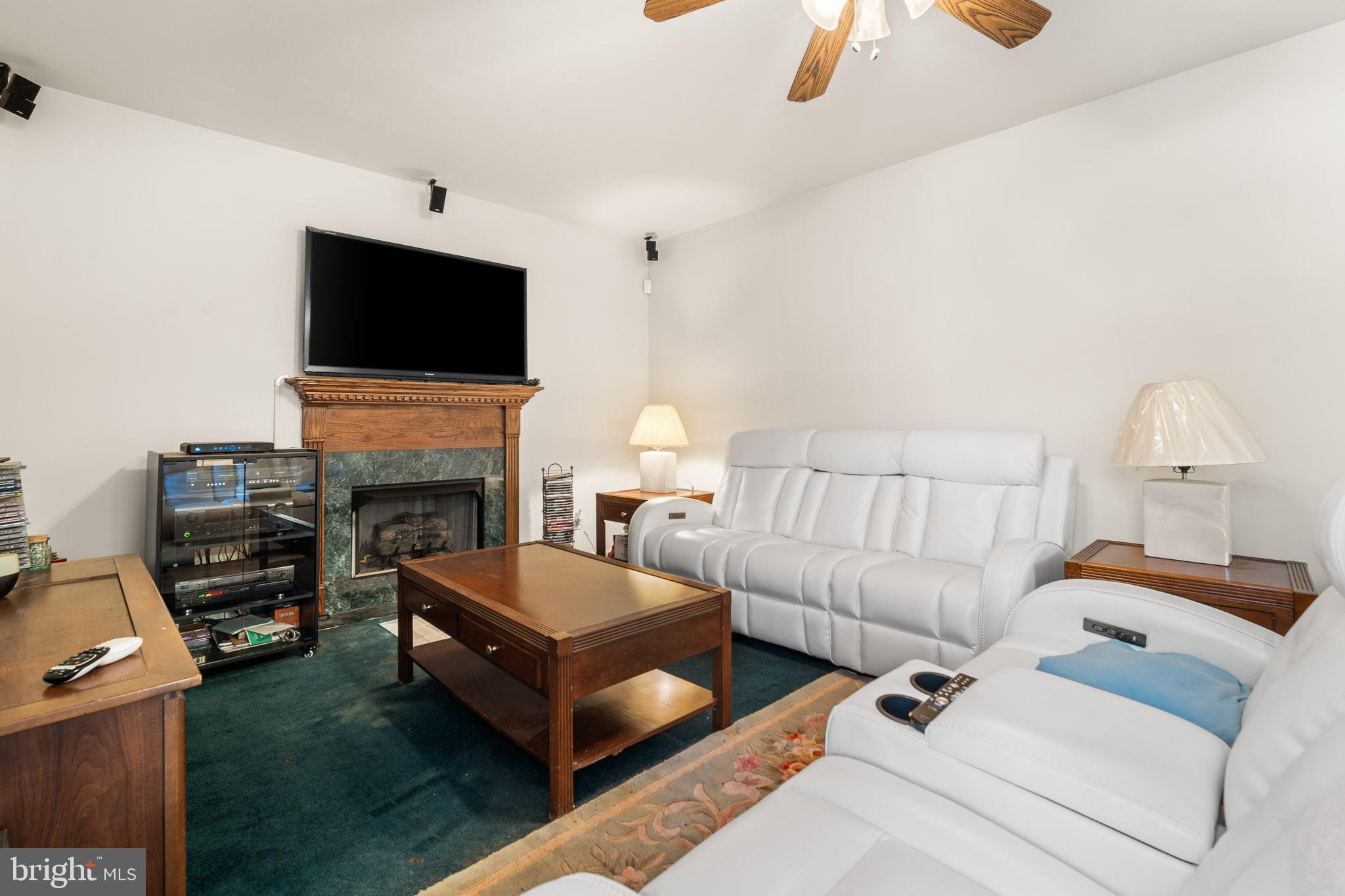 202 North New York Road Galloway Township, NJ 08205 - Photo 18 of 34 a living room with furniture a flat screen tv and a fireplace