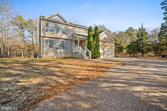 a front view of a building with a garden