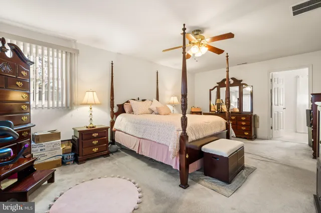 a spacious bedroom with a bed and a flat screen tv