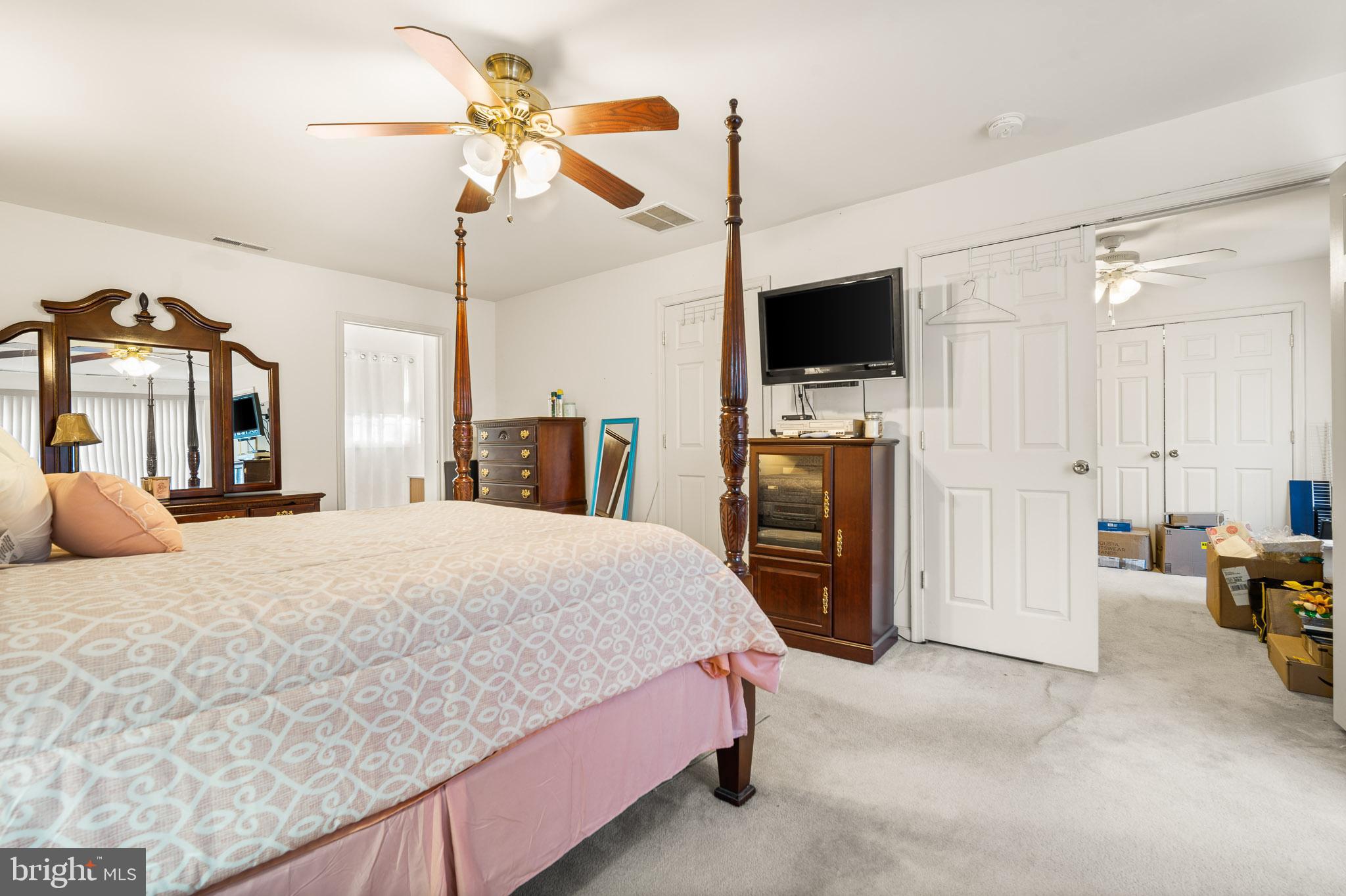 202 North New York Road Galloway Township, NJ 08205 - Photo 22 of 34 a spacious bedroom with a bed and a flat screen tv