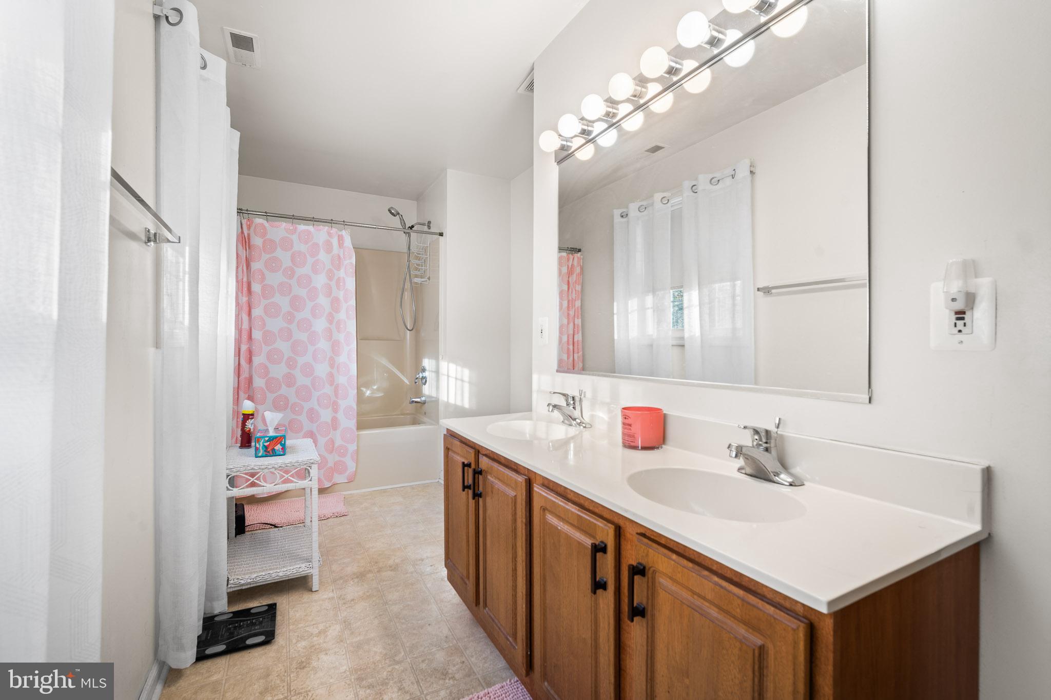 202 North New York Road Galloway Township, NJ 08205 - Photo 24 of 34 a bathroom with a sink double vanity and a mirror