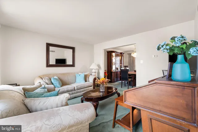a living room with furniture a piano and a flat screen tv