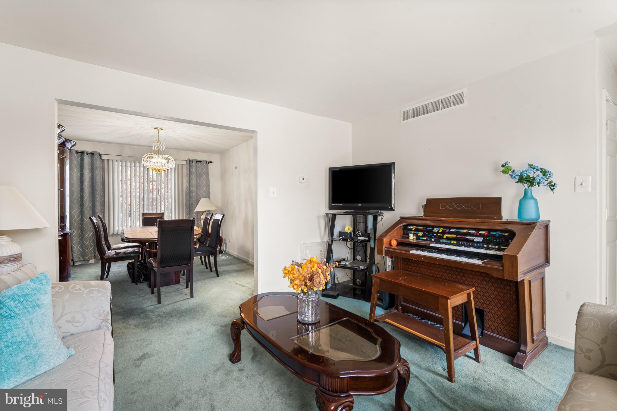 202 North New York Road Galloway Township, NJ 08205 - Photo 9 of 34 a living room with furniture a piano and a flat screen tv