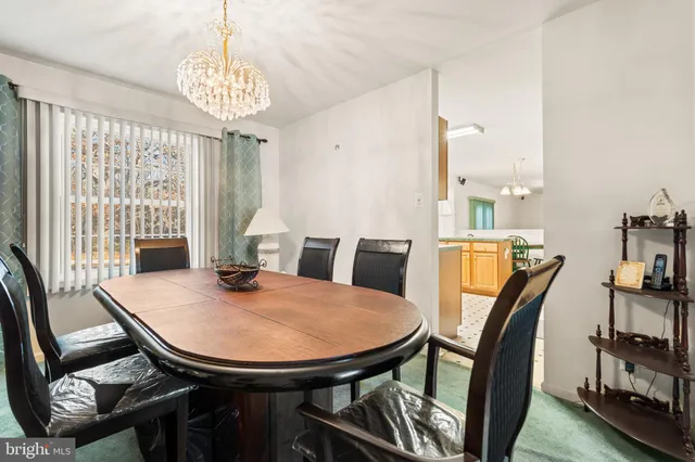 a view of a dining room with furniture and window