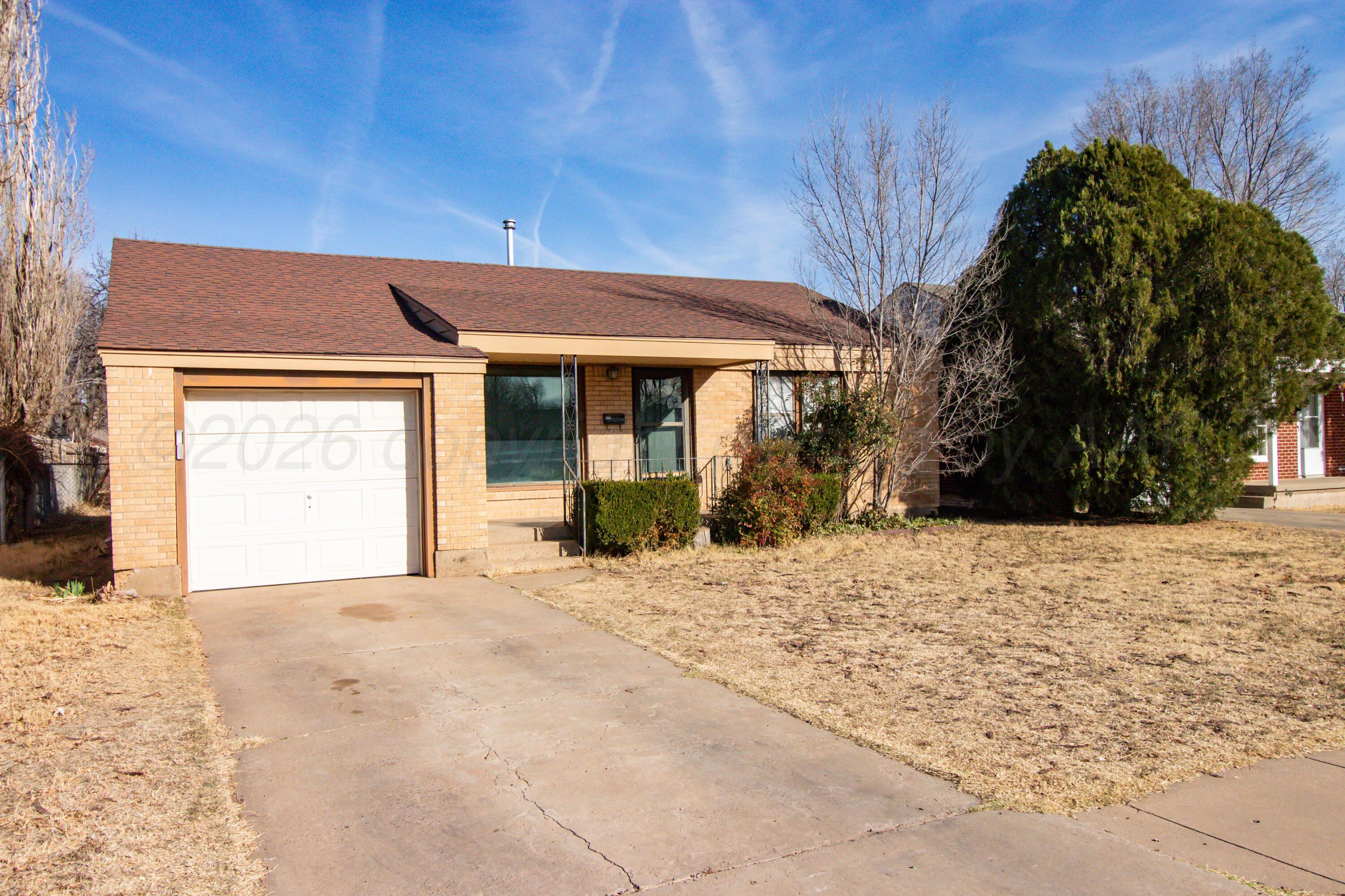 4211 South Travis Street Amarillo, TX 79110 - Photo 1 of 21 a view of a house with a yard