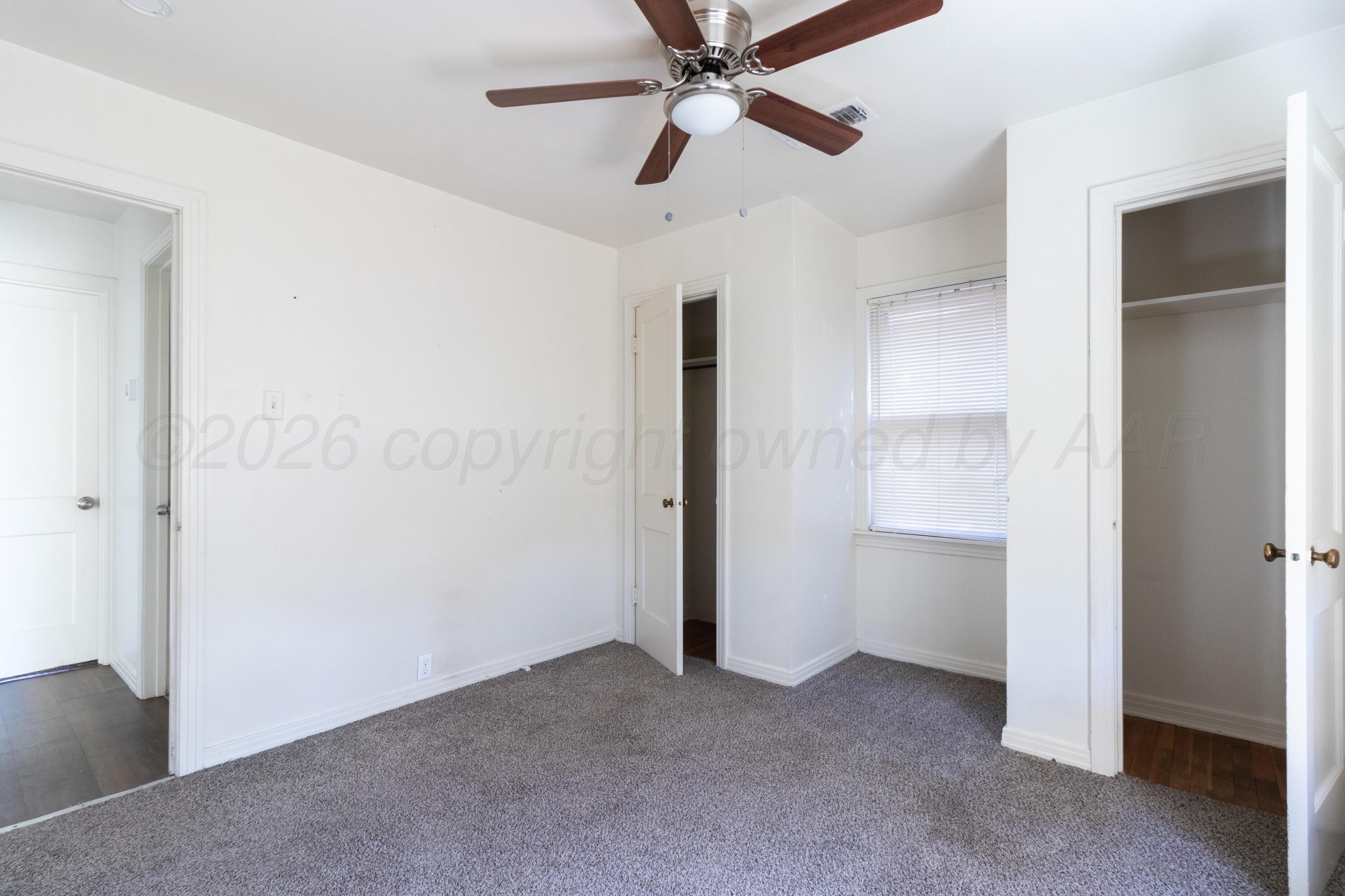 4211 South Travis Street Amarillo, TX 79110 - Photo 15 of 21 a view of empty room with closet and fan