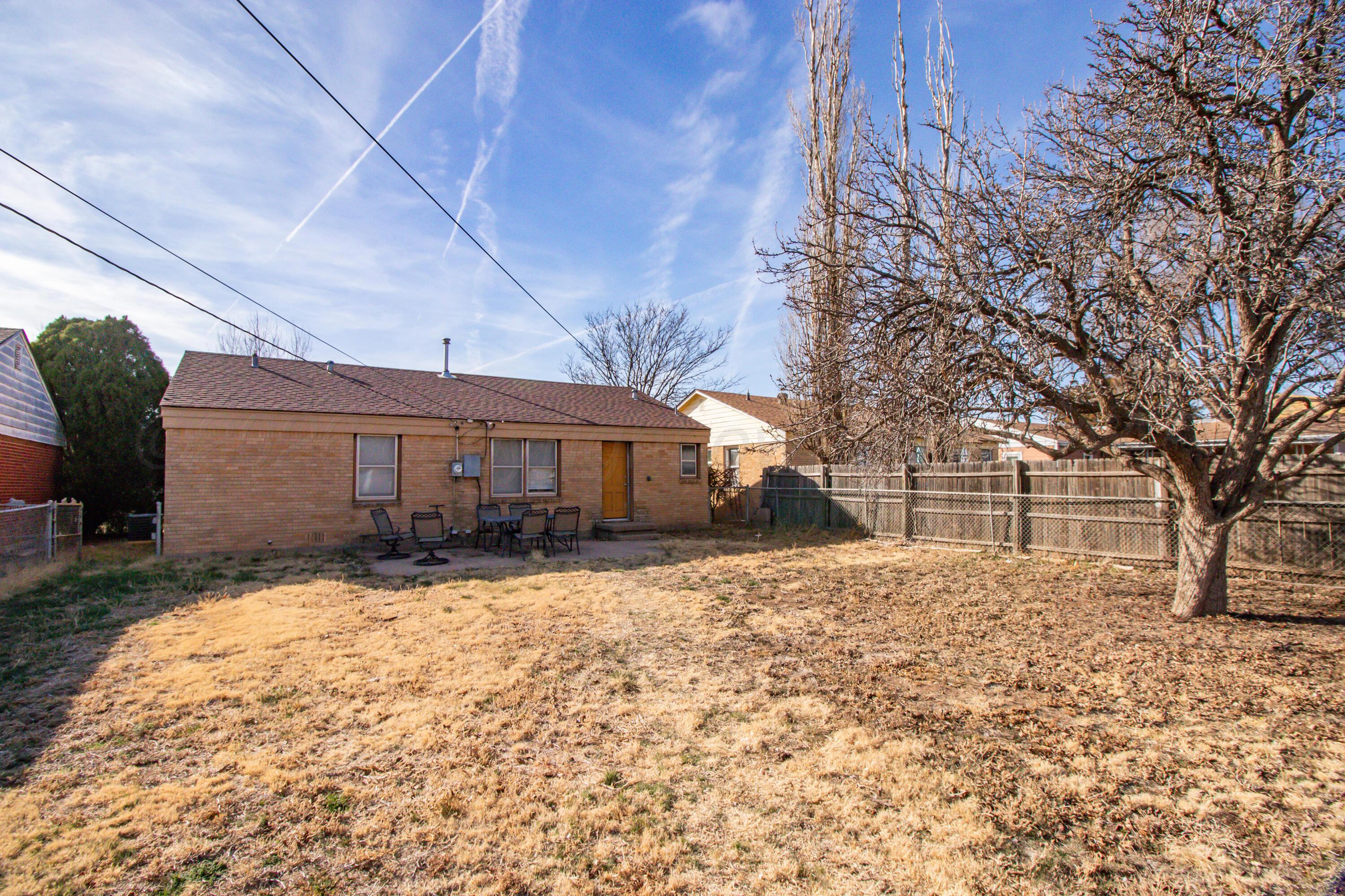 4211 South Travis Street Amarillo, TX 79110 - Photo 17 of 21 a front view of a house with a yard covered in snow