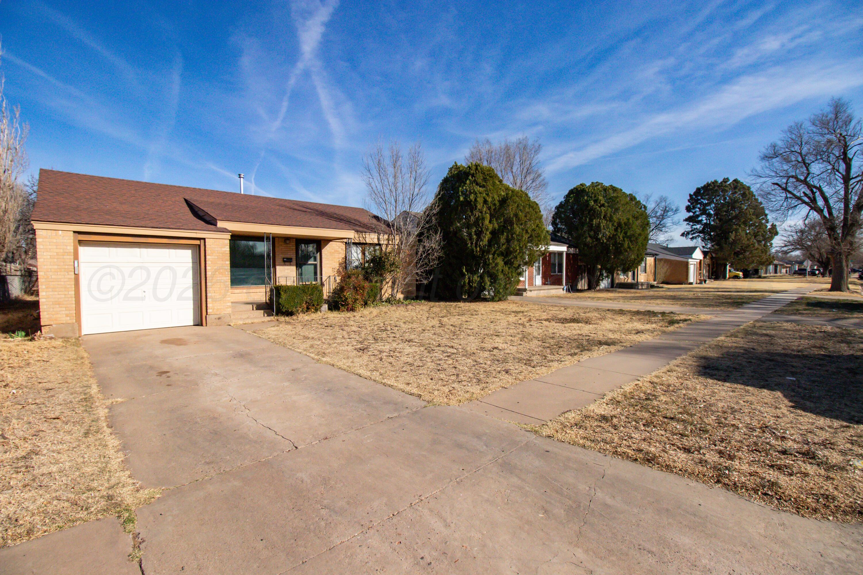 4211 South Travis Street Amarillo, TX 79110 - Photo 4 of 21 front view of a house with a yard