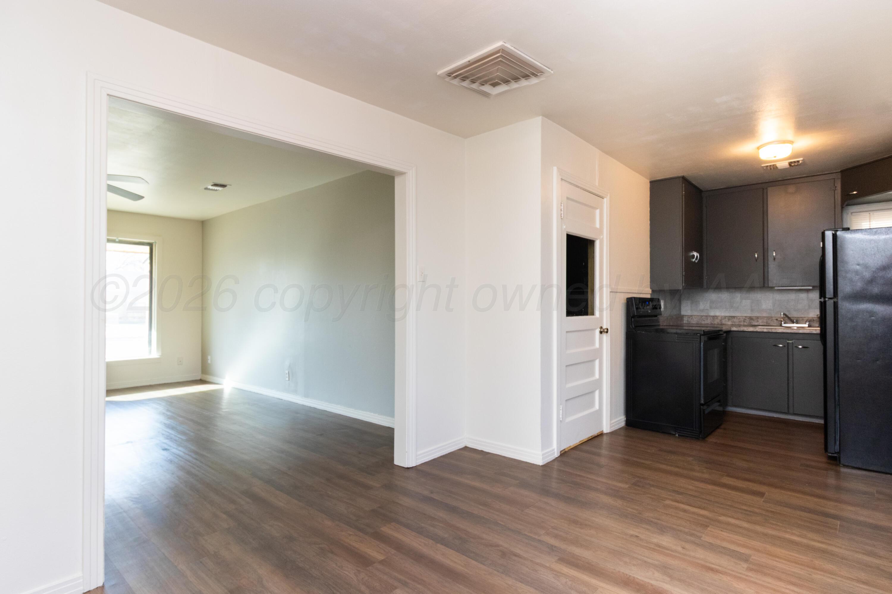 4211 South Travis Street Amarillo, TX 79110 - Photo 8 of 21 a view of a kitchen with a sink a refrigerator and window