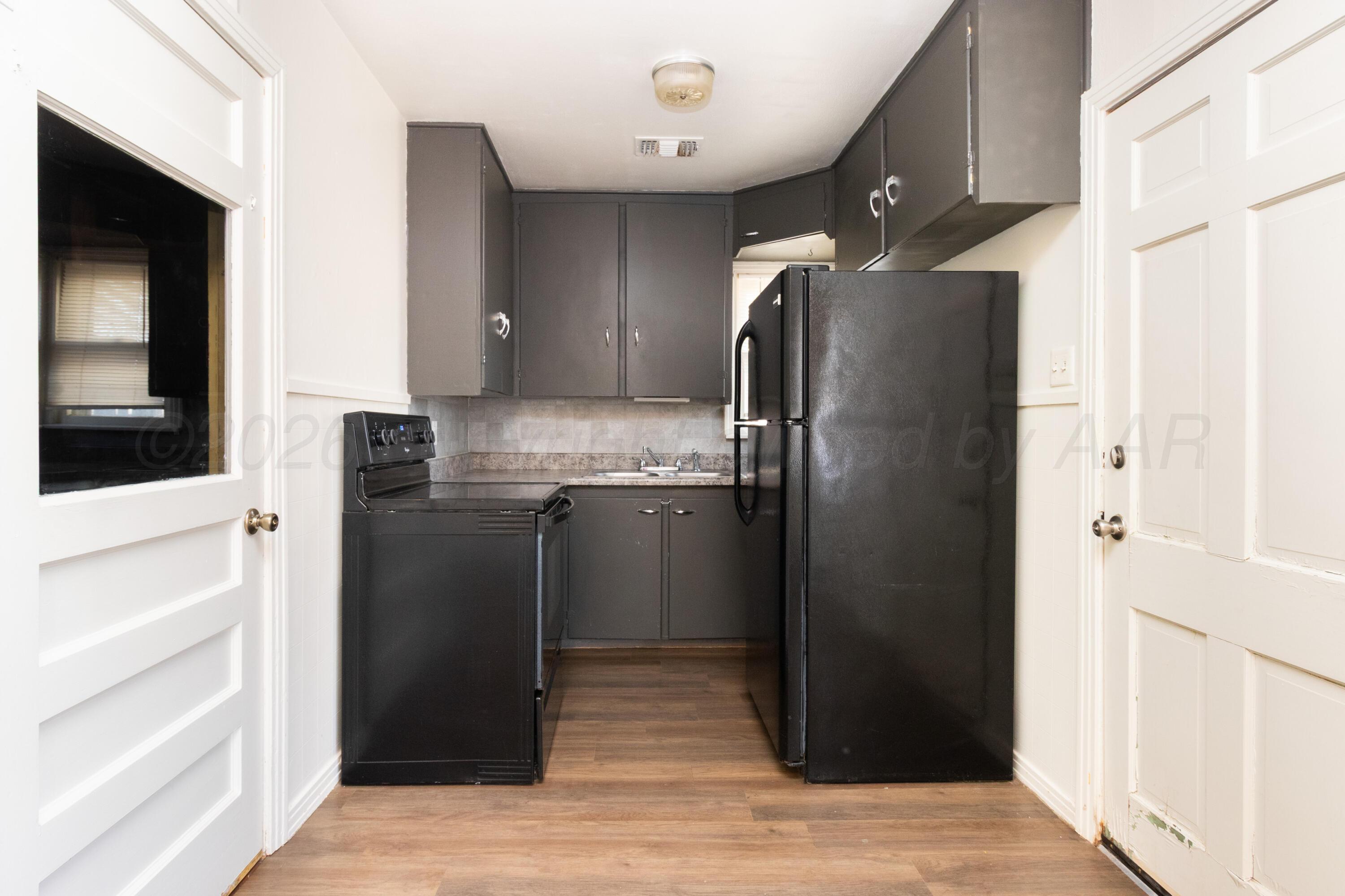4211 South Travis Street Amarillo, TX 79110 - Photo 9 of 21 a kitchen with stainless steel appliances granite countertop a refrigerator and a sink