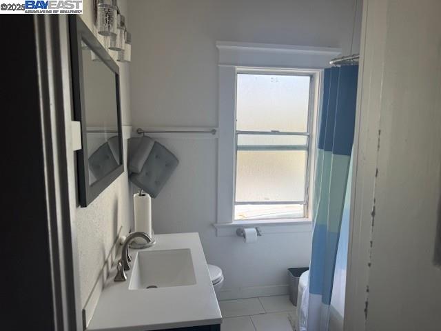 1009 Addison Street Berkeley, CA 94710 - Photo 17 of 34 a bathroom with a sink a toilet and a window