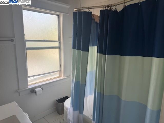 1009 Addison Street Berkeley, CA 94710 - Photo 18 of 34 a bathroom with a window and a shower