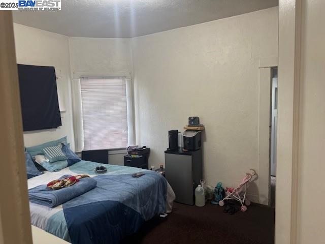 1009 Addison Street Berkeley, CA 94710 - Photo 19 of 34 a bedroom with a bed and wooden floor