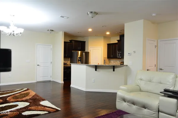 a room with wooden floor and gym equipment