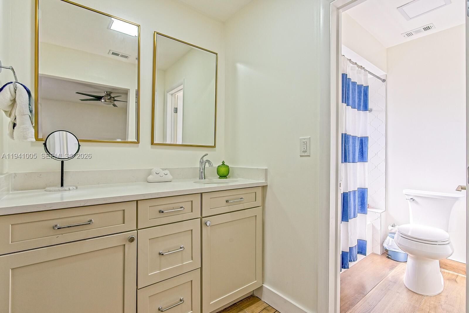 10900 Southwest 124th Road Miami, FL 33176 - Photo 15 of 22 a bathroom with a sink a toilet and a mirror