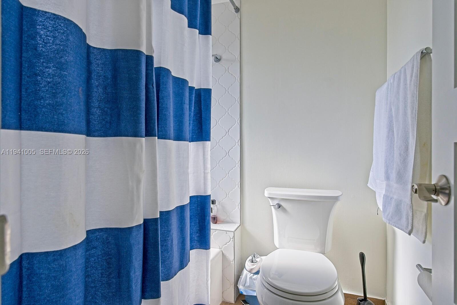 10900 Southwest 124th Road Miami, FL 33176 - Photo 16 of 22 a white toilet sitting next to a wooden cabinet