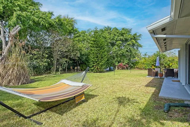 a view of a backyard with swimming pool