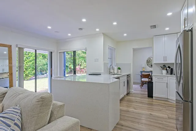 a living room with furniture and large windows