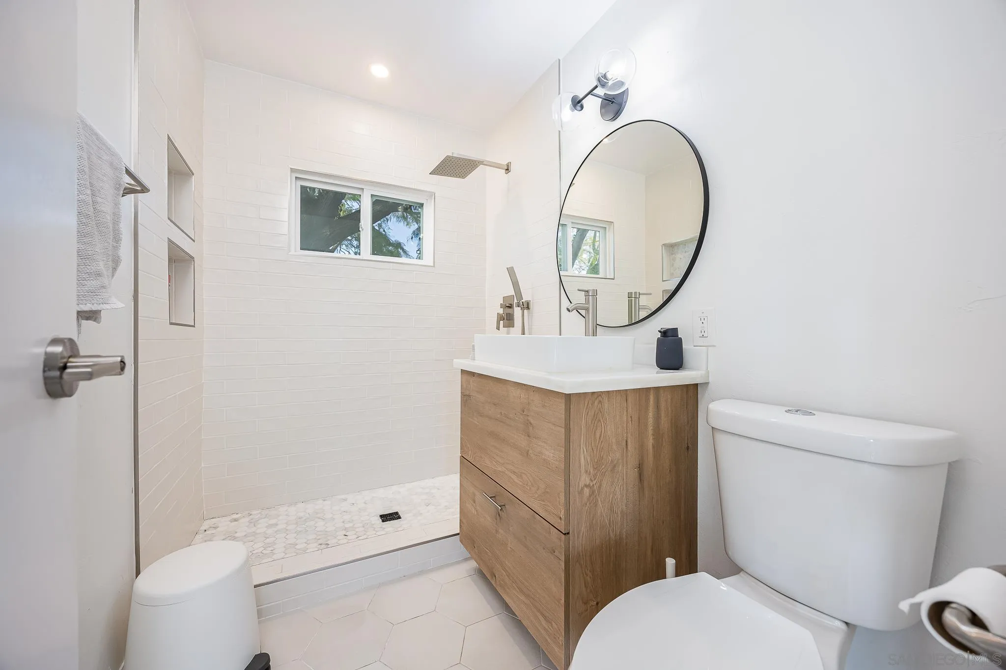 4344 Avon Drive La Mesa, CA 91941 - Photo 18 of 50 a bathroom with a toilet a sink and a mirror
