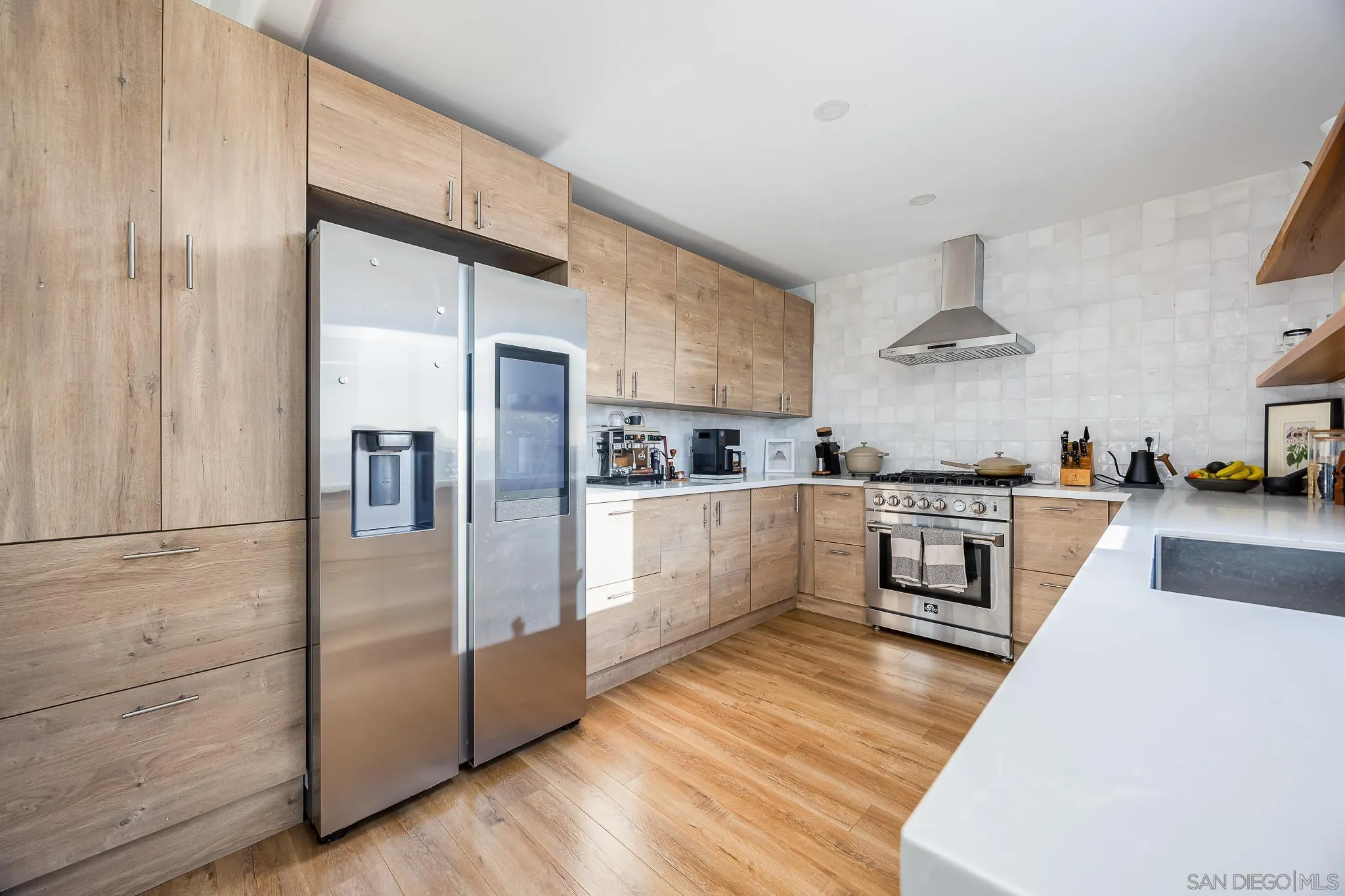 4344 Avon Drive La Mesa, CA 91941 - Photo 8 of 50 a kitchen with stainless steel appliances granite countertop a refrigerator a stove and a sink with wooden floors