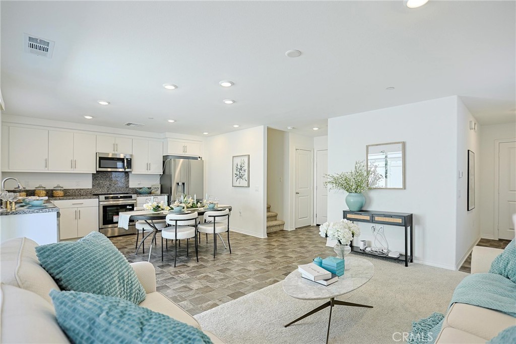 7486 Olive Grv Street Riverside, CA 92507 - Photo 2 of 57 a living room with furniture kitchen view and a dining table